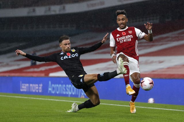 Pierre-Emerick Aubameyang, right, is tackled by Villa''s Matty Cash