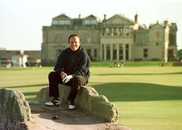 President Carlos Menem sits on Swilkem bridge before playing his second shot on the old course at St Andrews Royal & Ancient golf course (David Cheskin/PA)