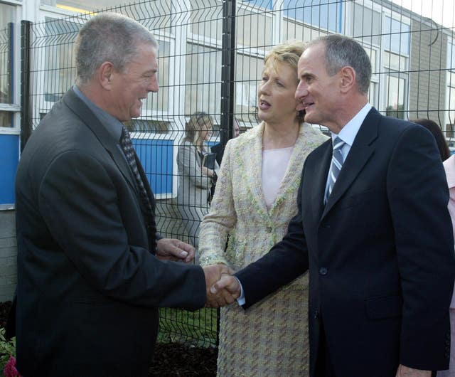 Irish President Mary McAleese and husband Martin are welcomed to Taughmonagh Primary School by loyalist leader Jackie McDonald in 2005