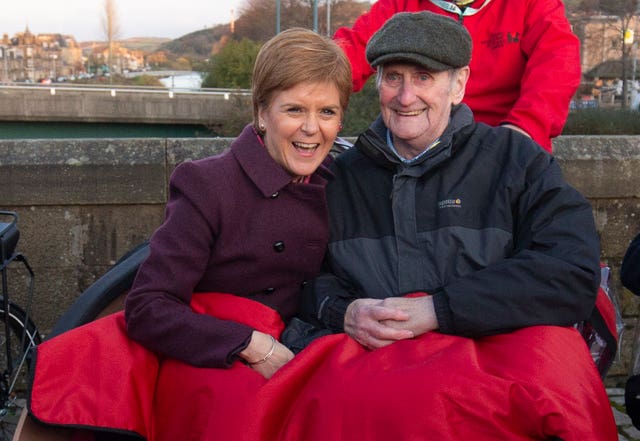 SNP leader Nicola Sturgeon joined Cycling Without Age user Cyril Corcoran, aged 78, in an electric tricycle during a visit to Hawick in the Scottish Borders