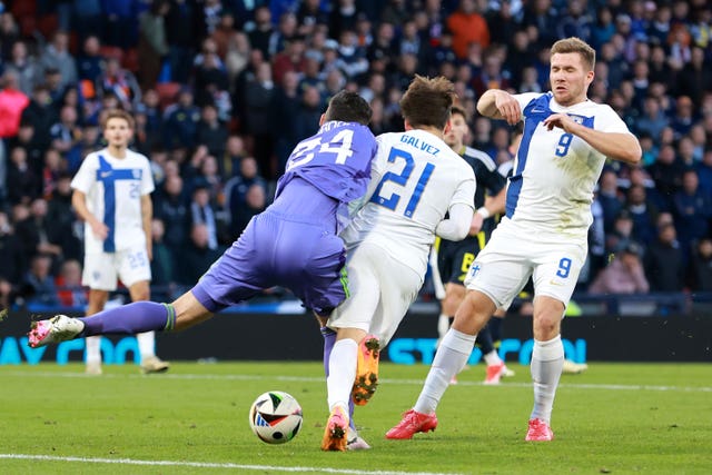 Scotland goalkeeper Craig Gordon, left, collides with Finland’s Finland''s Tomas Galvez to concede a penalty