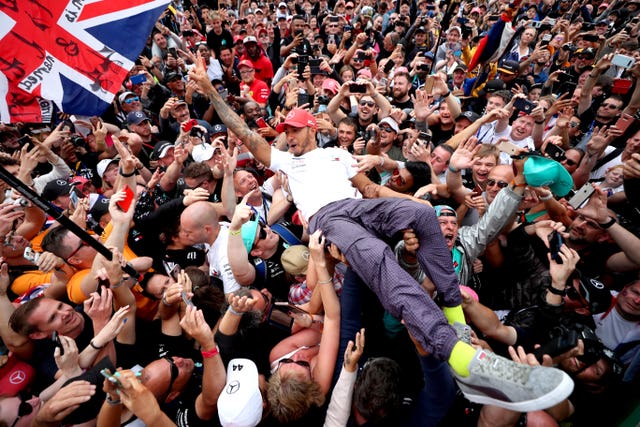 Lewis Hamilton soaked up the adulation from Silverstone spectators in 2019, celebrating another win by crowd surfing