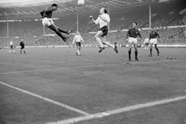 Portugal's Eusebio jumps for the ball with England's Stiles during the World Cup semi-final at Wembley, which England won 2-1