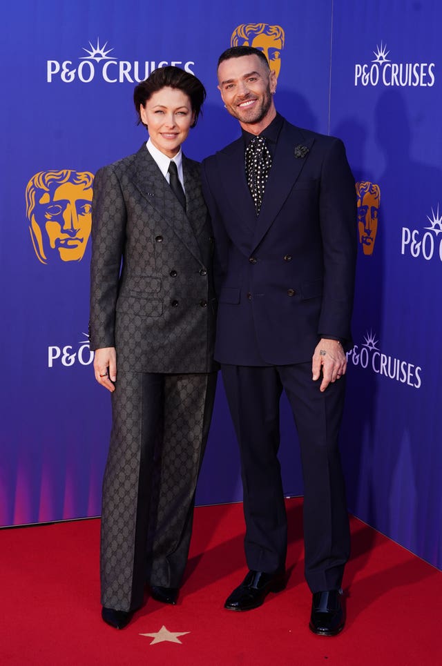 Emma and Matt Willis smiling on a red carpet