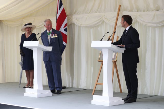 The Duchess of Cornwall and the Prince of Wales alongside French president Emmanuel Macron as he delivers a speech during a ceremony at Carlton Gardens in London