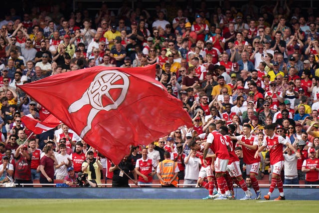 Arsenal’s Cedric Soares is mobbed by team-mates after scoring