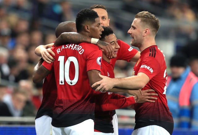Marcus Rashford, left, is embraced by team-mates after his winner against Tottenham