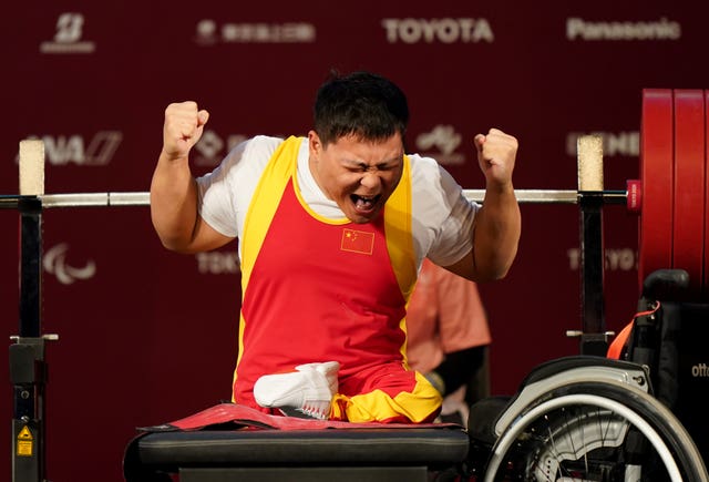 China’s Yongkai Qi struggles to contain his delight after the third lift in the Men’s -59 kg Final