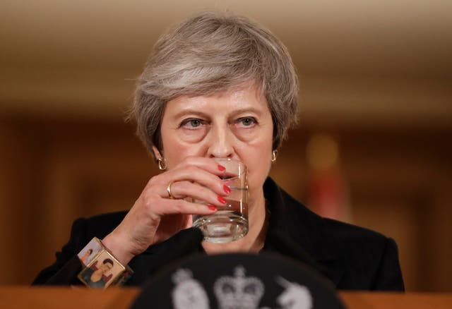 Theresa May takes a sip of water as she holds a press conference at 10 Downing Street 