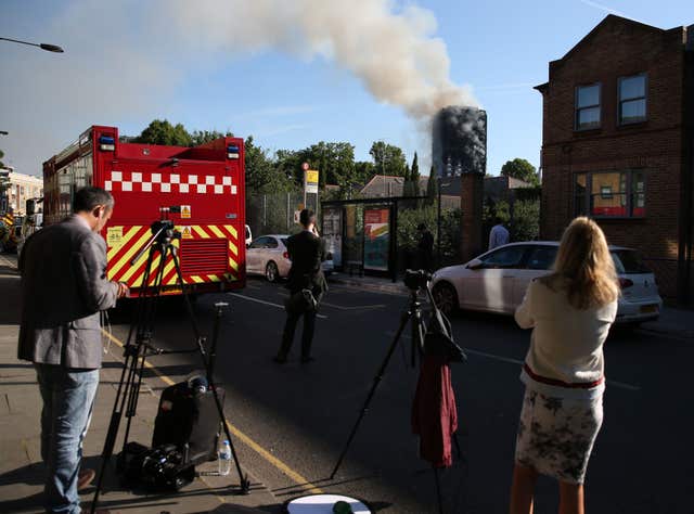 Emergency services and media at the scene of the fire (Steve Paston/PA)