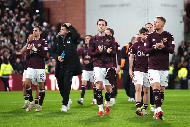 Hearts player applaud fans as they walk around the Tynecastle pitch