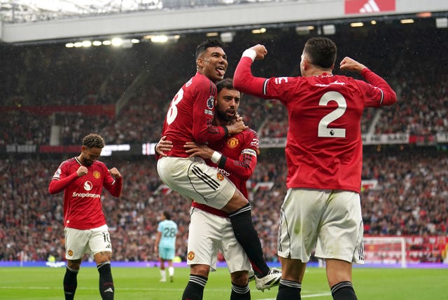 Manchester United’s Casemiro (centre left) celebrates with team-mate Bruno Fernandes after his shot is turned in by Burnley’s Josh Cullen
