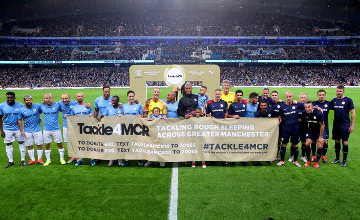 Vincent Kompany lines up between the two teams before kick-off