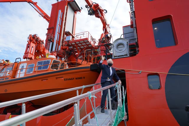 Boris Johnson boards a boat