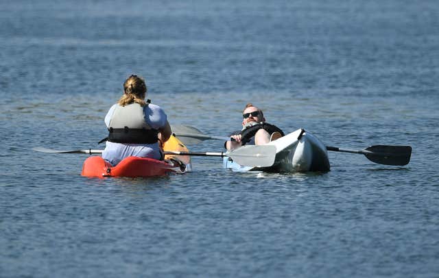 People relax on kayaks at Nene Park in Peterborough