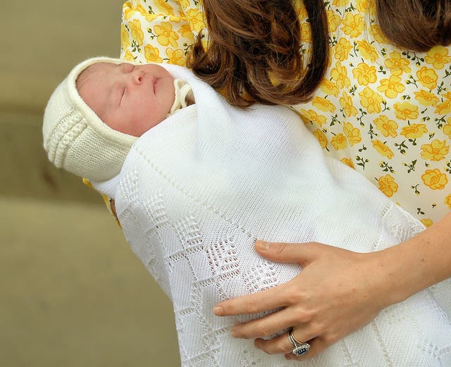 Princess Charlotte of Cambridge in the arms of her mother the Duchess of Cambridge outside the Lindo Wing (John Stillwell/PA)