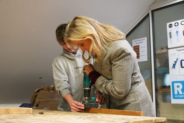 Sophie is helped by 15-year-old student Alfie during her visit to the RAW Workshop