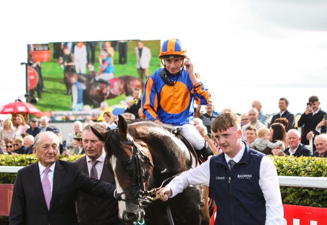 Scandinavia and jockey Ryan Moore are led into the winner's enclosure