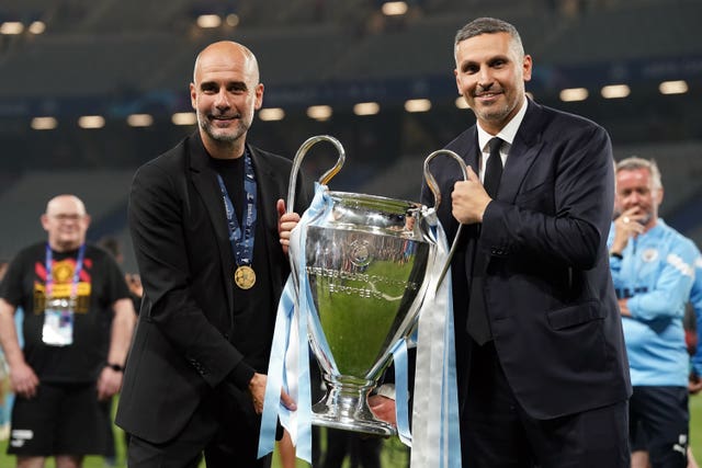 Manchester City's then manager Pep Guardiola and chairman Khaldoon Al Mubarak are pictured with the Champions League trophy in 2023