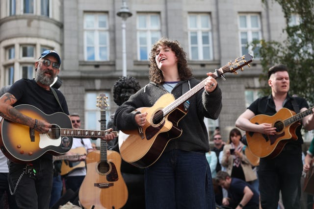 Musicians play in memory of Glen Hansard on King Street in Dublin