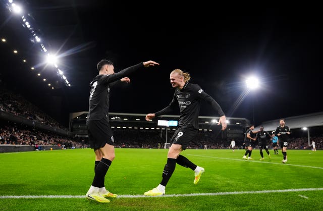 Manchester City’s Phil Foden (left) celebrates scoring his sides fourth goal with Erling Haaland