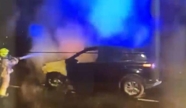 Screengrab from a video of firefighters tackling a burning car in the same north London street where Prime Minister Sir Keir Starmer has a property