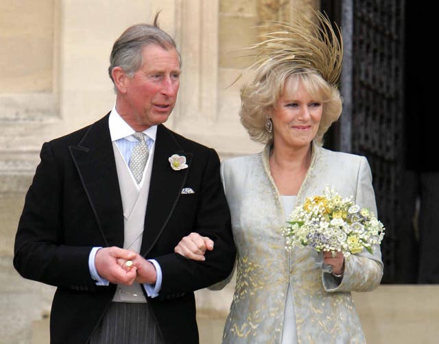 The Prince of Wales and his bride the Duchess of Cornwall leave St George’s Chapel (PA)