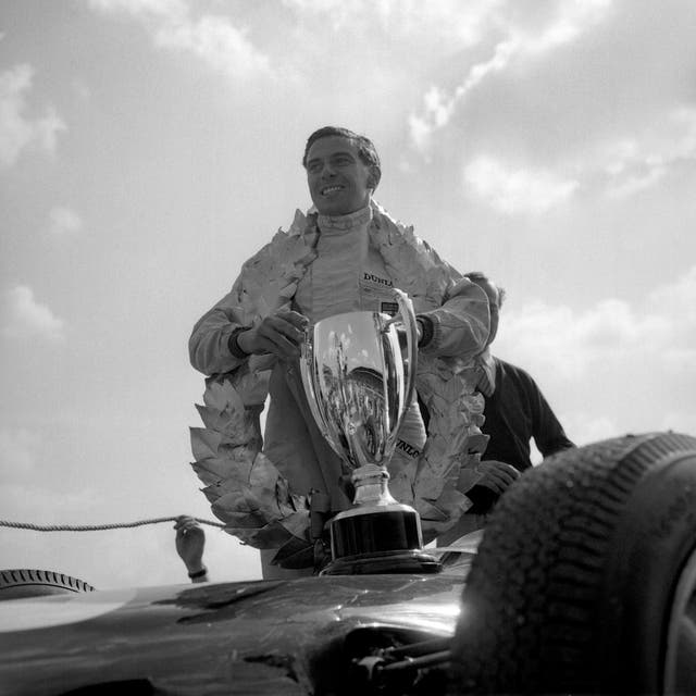 Lotus driver Jim Clark wears the garland of honour and proudly clutches his trophy after his 1963 triumph. The Briton won the British Grand Prix five times in six years during the 1960s, including successes at Aintree and Brands Hatch