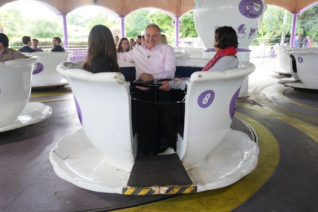 Liberal Democrats leader Sir Ed Davey sat on a teacup ride during a visit to Thorpe Park in Chertsey, Surrey, whilst on the General Election campaign trail