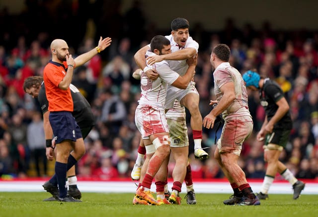 Sandro Mamamtavrishvili, left, Luka Matkava, centre, and Beka Saghinadze, right, celebrate victory 