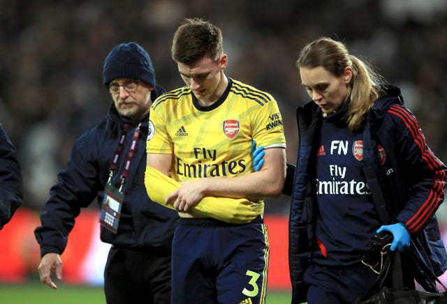 Kieran Tierney leaves the field with a shoulder injury against West Ham in December
