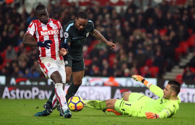 Jack Butland looks to prevent Raheem Sterling from scoring