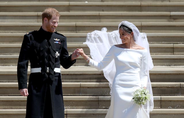 The Duke and Duchess of Sussex leave St George’s Chapel in Windsor Castle on their wedding day May 19, 2018. Jane Barlow/PA Wire