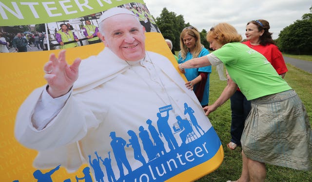 Volunteers disassemble a backdrop