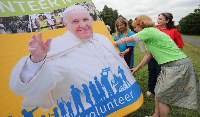 Volunteers disassemble a backdrop 