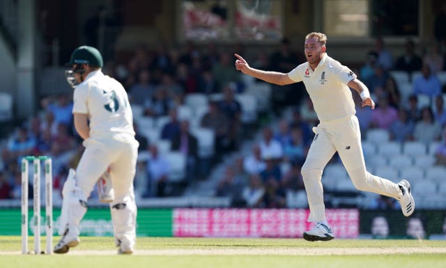 Stuart Broad celebrates taking the wicket of David Warner during day four of the fifth Test