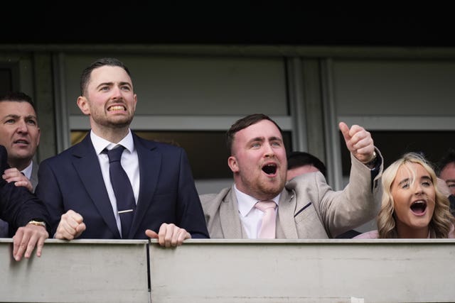 (left to right) Nathan Aspinall, Luke Humphries and Luke Littler with his partner Faith Millar attending day one of the 2026 Cheltenham Festival 