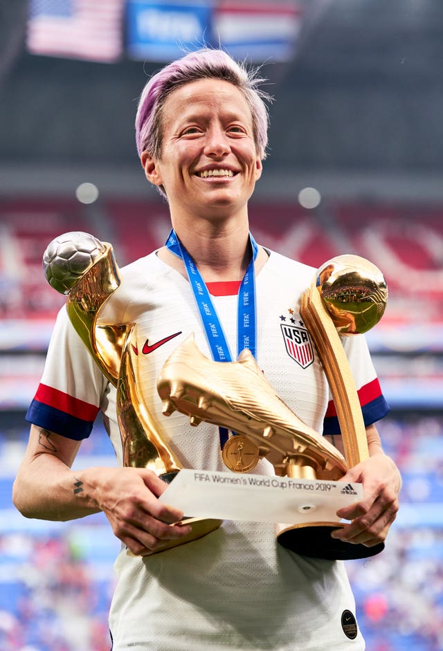 USA’s Megan Rapinoe celebrates with her adidas Golden Boot award, adidas Golden Ball award, and Fifa Women’s World Cup Trophy after the final