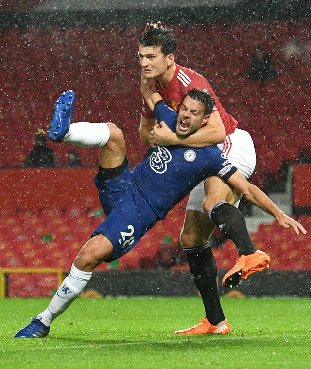 Harry Maguire tussles with Cesar Azpilicueta 
