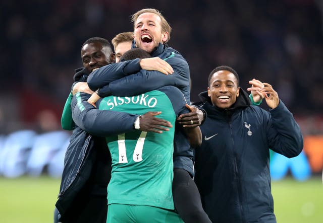 Injured striker Harry Kane celebrates with Moussa Sissoko
