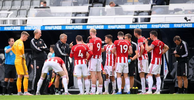 Chris Wilder talks to his players during a drinks break at St James' Park