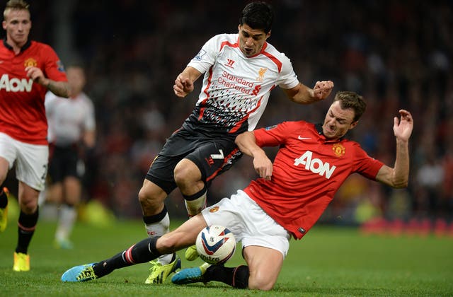 Jonny Evans, right, won three Premier League titles at United