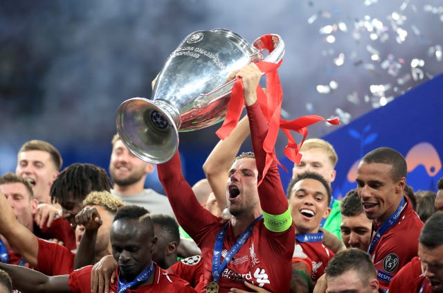 Liverpool’s Jordan Henderson lifts the Champions League trophy