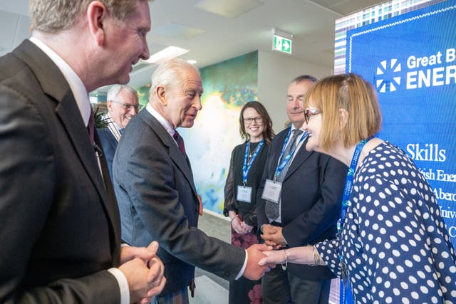 Charles shaking hands with a woman