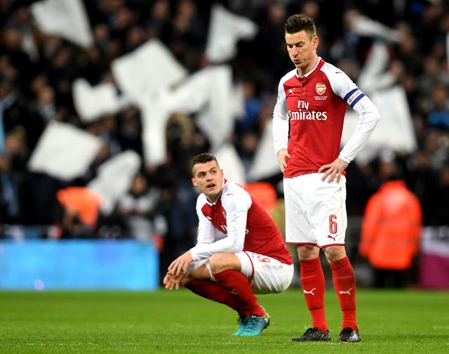 Arsenal’s Granit Xhaka (left) and Arsenal’s Laurent Koscielny (right)  are facing fitness tests ahead of the Napoli tie.