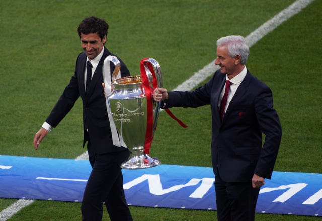Ian Rush and Raul carry the trophy out