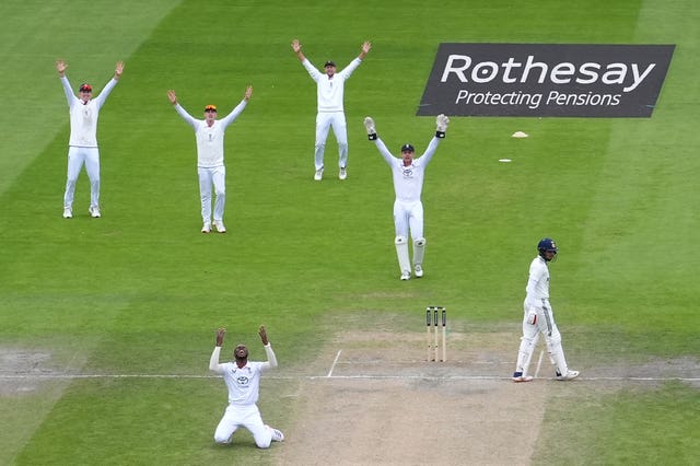 Jofra Archer (foreground) appeals for a wicket alongside the England slips.