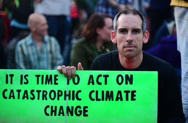 Olympic gold medallist Etienne Stott joins Extinction Rebellion demonstrators on Waterloo Bridge in London (Victoria Jones/PA)