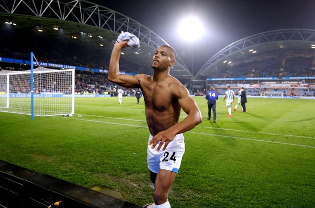 Match-winner Steve Mounie throws his shirt to fans