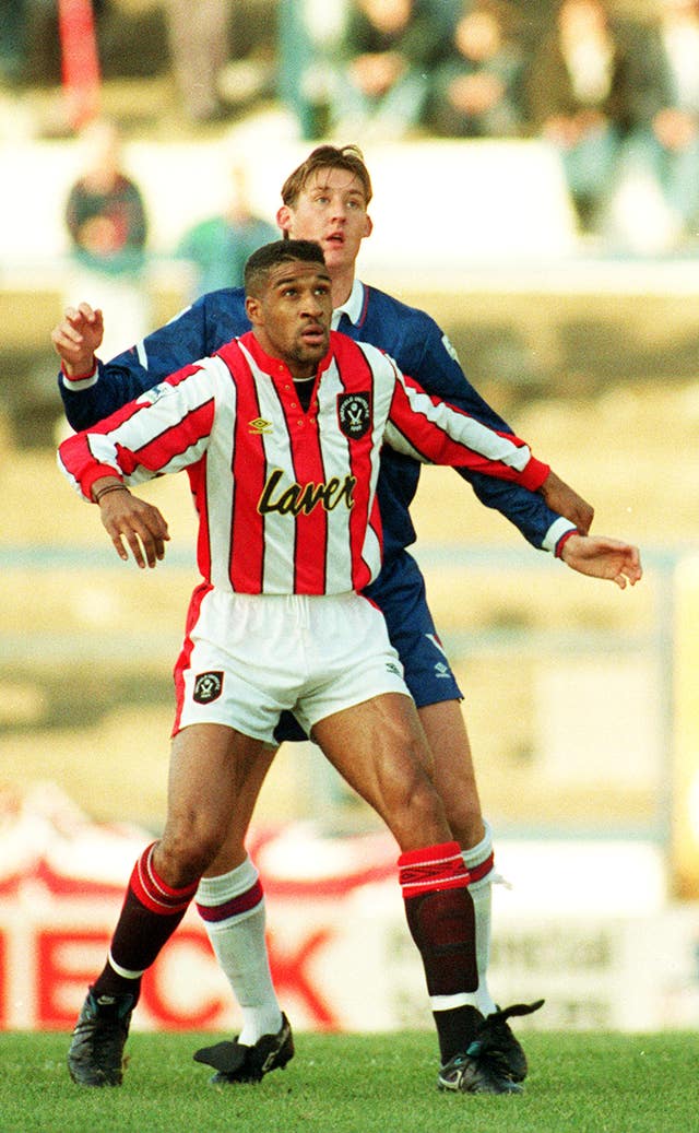 Brian Deane tussles with Chelsea's David Lee in a match at Stamford Bridge